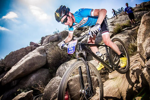 Cyclist navigating rocky trail with Flat Bar MTB Stem Mount For A Clean Cockpit One Accessory At A Time Mount A Computer Camera