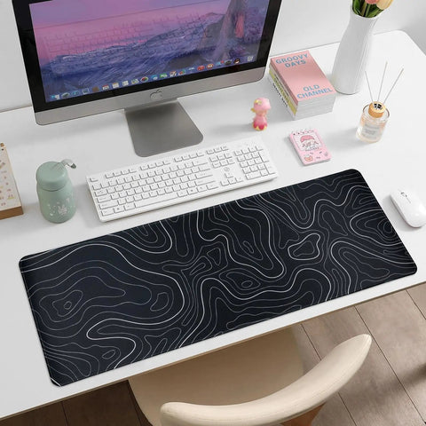 Large Topographic Gaming Mouse Pad 31.5 By 11.8 Inches With Smooth Surface Grippy Non Slip Base And Stitched Edge Extended Desk Pad XL Desk Mat For Gaming And Work Black on desk with keyboard and computer monitor