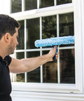 Person using 2-In-1 Window Cleaner Squeegee And Scrubber With Stainless Steel Handle, Microfiber Pad on home window