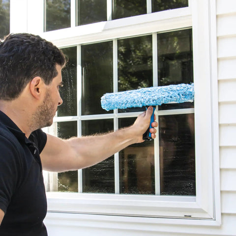 Person using 2-In-1 Window Cleaner Squeegee And Scrubber With Stainless Steel Handle, Microfiber Pad on home window