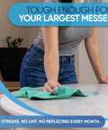 Person cleaning a countertop with a green microfiber cloth from the 50 Pack 16x16 Microfiber Cleaning Cloths All Purpose Shop Rags For Janitorial Auto Detailing Restaurants And Home Use Reusable Machine Washable Yellow