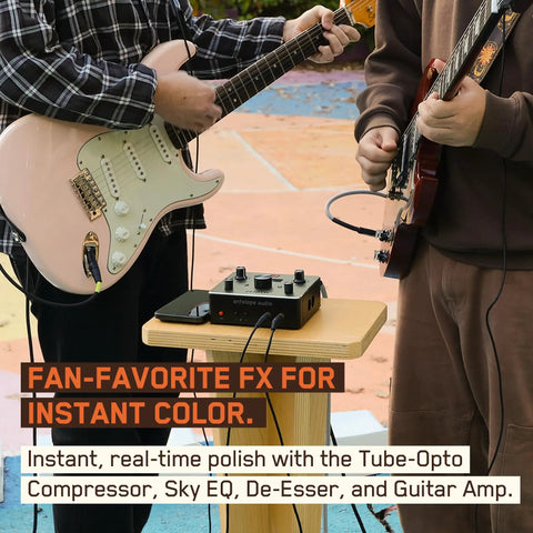 Two guitarists using Zenith 2 USB C Audio Interface For Guitar, Vocals, Streaming And Podcasting on wooden stand outdoors.