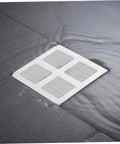 Nukinp Disposable Hair Drain Stickers, 60 Pack 4x4 Fiberglass Disposable Drain Covers on a wet floor near shower drain.