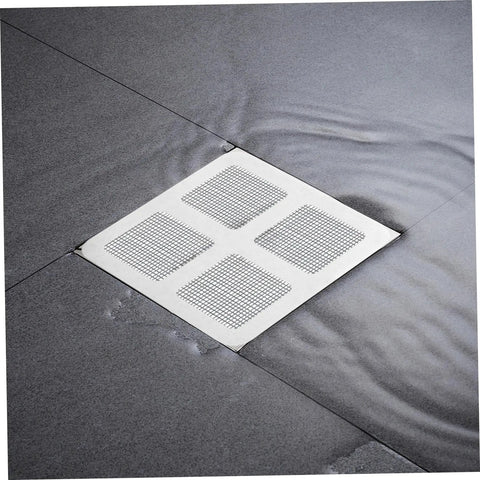 Nukinp Disposable Hair Drain Stickers, 60 Pack 4x4 Fiberglass Disposable Drain Covers on a wet floor near shower drain.
