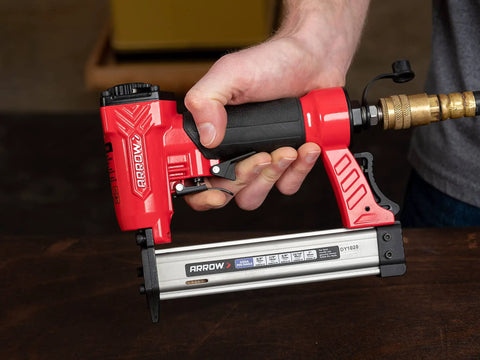 Hand holding Lightweight 23 Gauge Pin Nailer Oil Free Pneumatic Tool PT23G Accepts Nails From Three Eighths To One Inch