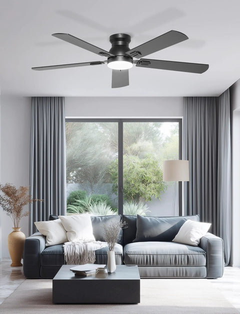 Sleek 52 Inch Black Flush Mount Ceiling Fan With Low Profile Frame And Soft Ambient Lighting Delivers Solid Airflow Without Dropping Down Or Cluttering Your Space in a modern living room.
