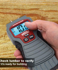 Person using 7440 AccuMASTER XT Digital Moisture Meter Handheld Pin Type With Backlit LCD Display on wood surface