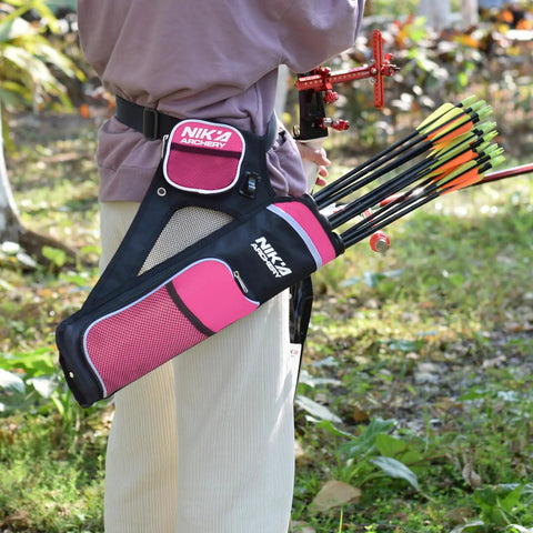 Person wearing pink Archery Hip Quiver With Three Detachable Arrow Tubes outdoors, featuring adjustable nylon pockets.