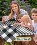 Family using Picnic Table Cover With Bench Covers 72x30 Inches 3 Piece Set in black check pattern, waterproof feature highlighted.