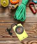 Orienteering Compass High Precision Acrylic Navigation Tool for Survival and Camping on wooden surface with hiking gear