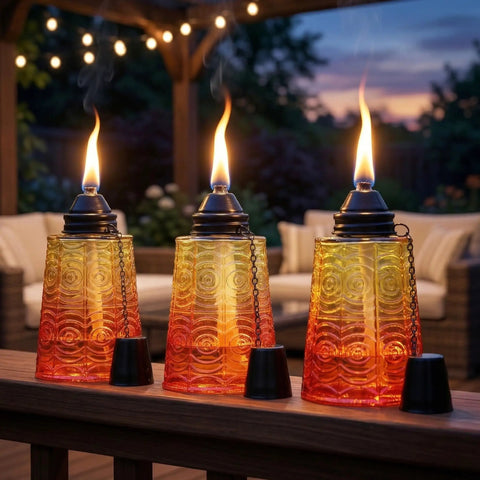 Citronella Glass Table Top Torches For Outdoor Patio 16oz Set Of 3 red, yellow, and orange decorative torch candles lit on a deck.