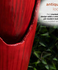 Close-up of 33 Inch Outdoor Vintage Cascading Antique Jar Water Fountain With LED Lights Red Finish For Garden, showing cracked design.