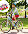 Kid cycling with 216 Piece Bicycle Spoke Beads Kit With Assorted Color Plastic Clip Beads For Wheel Decoration; storage box shown