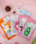 Beads For Crafts Kit With 12 Design Pony Beads And Letter Beads, Keychain Making Set with pouches and bead art on display table.