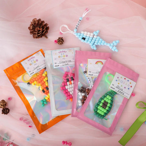 Beads For Crafts Kit With 12 Design Pony Beads And Letter Beads, Keychain Making Set with pouches and bead art on display table.