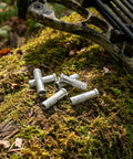 12 Piece Aluminum Arrow Inserts For 0.244 Inch And 6.20mm Carbon Arrow Shafts on moss with camo bow.