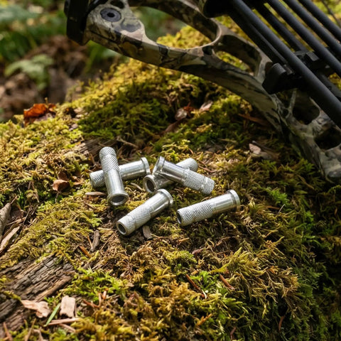 12 Piece Aluminum Arrow Inserts For 0.244 Inch And 6.20mm Carbon Arrow Shafts on moss with camo bow.