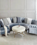 Curved blue velvet sofa with white round table, showcasing Heightened Waterproof Acrylic Furniture Legs: Heavy-Duty Support For Kitchen Cabinets.