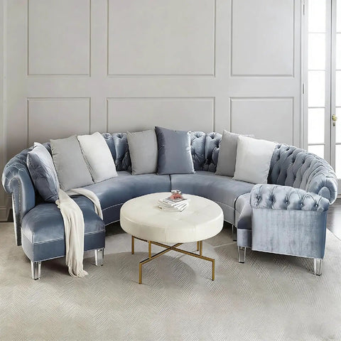 Curved blue velvet sofa with white round table, showcasing Heightened Waterproof Acrylic Furniture Legs: Heavy-Duty Support For Kitchen Cabinets.
