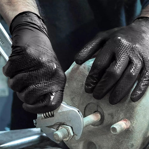 TitanFlex heavy-duty black nitrile gloves, XL, 8-mil, close-up of gloved hands using a wrench