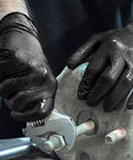 Top Tier Heavy Duty Black Nitrile Gloves 8 Mil Thick Build Real Deal Industrial Grip Engineered For Daily Mechanic Grind And Auto Shop Jobs Powder Free Latex Free Food Safe hands gripping a wrench.