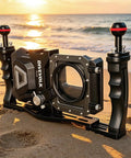Beefy Dual Handle Underwater Camera Tray Bracket With Standard Quarter Inch 20 Thumb Screws on sandy beach at sunset