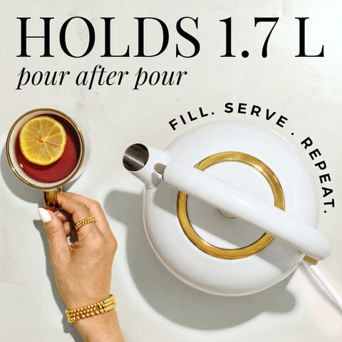White and gold electric kettle with lemon tea, top view, showing sleek design and holding 1.7L. High Temperature Control Electric Kettle With 1500W Rapid Boil And Keep Warm Function Glass Body BPA Free Design White And Gold Finish Auto Shut Off Sleek Modern Design For Tea Lovers And Daily Hydration.
