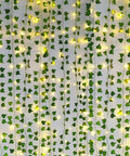 Fake Ivy Vines With 80 LED String Lights 12 Pack 84 Feet Total Length For Indoor Outdoor Decor hanging on a wall