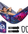 Person relaxing in colorful Ultralight Two-Person Camping Hammock For Backpacking And Festivals with ropes and carabiners
