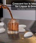 Glass of liquor with crescent ice from drainless under counter ice maker with 22lb storage bin free standing or built in