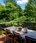 Outdoor deck with 600 foot deck railing cable kit one eighth inch diameter stainless steel T316 7x7 wire, surrounded by trees.