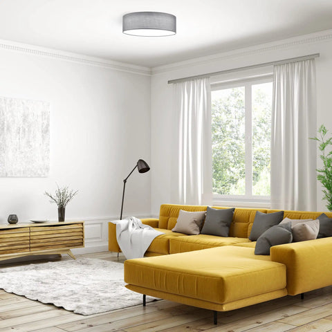 Living room with Flush Mount Drum Ceiling Light With Remote Control, 12.6 Inch Diameter LED Fixture, Gray Fabric Shade above yellow sofa.