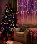 12 Star Multicolor Curtain Lights With 138 LEDs Eight Point Two Ft Connectable Window String Lights hung beside a decorated Christmas tree.