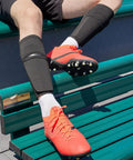 Soccer Shin Guard Sleeves With Insert Pocket And Top Lid, breathable mesh, black, size large, worn by player on bench.