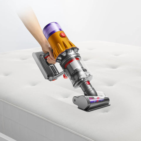 V12 Detect Slim Absolute Cordless Vacuum Cleaner With High Suction Power Ultra Lightweight Design in use on mattress