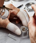 Watch Band Pins Replacement Kit For Metal Watch Straps With Spring Bars on table with a precision repair tool in use