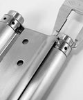 Close-up of Heavy Duty Stainless Steel Auto Closing Hinges showing brushed finish and pivot mechanism for commercial door use.