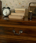 Antique Brass Cabinet Pulls Three And One Quarter Inch Center European Style Decorative Drawer Handles on wooden dresser