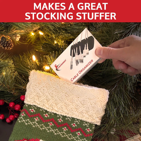 Hand placing Must Have Weighted Desktop Cable Organizer in Christmas stocking near tree