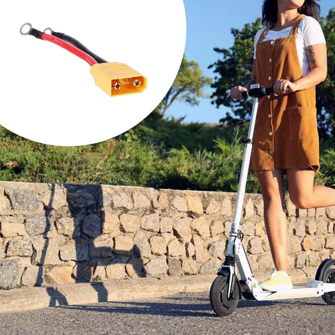 XT90 Electric Scooter Charging Cable With Battery And Motherboard Adapter next to person on electric scooter outdoors