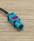 Close-up of Fakra Z Male To Male Vehicle Antenna Adapter Cable 30 cm RG174 coax connector on wood surface, used for DAB GPS FM.