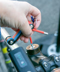 Close-up of hand using Go To Bike Repair Multitool Kit 9 In 1 For On The Go Fixes Durable CrV Steel on bike