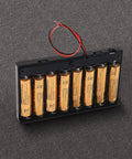 Kickass Hella Heavy Duty Eight Cell AA Battery Holder Box with reinforced lead wires and toggle switch on a dark surface.