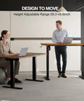 Two people using an Electric Standing Desk With Easy Height Adjust, Memory Presets And Cable Management, Rustic Brown Sit Stand Desk For Work From Home, Ergonomic Computer Desk 48 Inch By 24 Inch with laptops