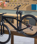 360 Degree Rotating Bike Repair Stand for Bench Mount Work Stand with E-Bike and Mountain Road Bike, holds up to 88 lbs, in workshop setting