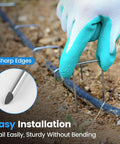 Heavy Duty Garden Stakes 50 Pack 6 Inch 11 Gauge Landscape Staples installed in soil for gardening and landscaping.
