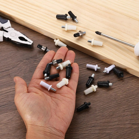 Hand holding Rock Solid Spring Loaded Shutter Repair Pins 80 Piece White Set Quick Fix Hardware for blinds and cabinet doors.
