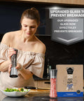 Woman using Stainless Steel Salt And Pepper Grinder Set Of 2 With Adjustable Ceramic Mills in kitchen next to packaging and salad