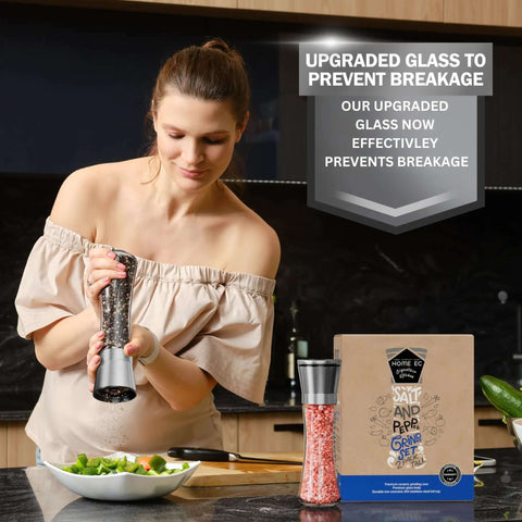 Woman using Stainless Steel Salt And Pepper Grinder Set Of 2 With Adjustable Ceramic Mills in kitchen next to packaging and salad