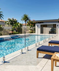 Top Tier Frameless Tempered Glass Railing Kit For Outdoor Decks, 44 Inch Height by pool with stainless steel posts and glass panels.